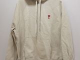 the hoodie is hanging on a hanger on the wall