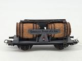 a small model train with a barrel on it