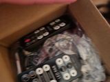 someone is opening a box with a bunch of remotes inside of it