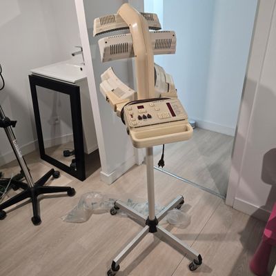 a computer sitting on a stand in the corner of a room