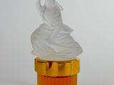 a plastic statue of a woman sitting on top of a yellow container
