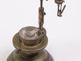 an antique brass plate with a compass on top of it