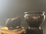 a bowl and a bowl on a stand next to each other