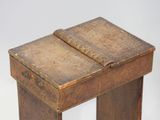 a small wooden table with a book on it