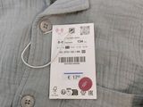 a buttoned shirt with a price tag attached to it