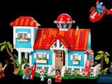 a small toy house with a red roof and a red roof