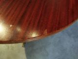 a close up of a wooden table with a clock on it