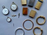 many different types of watches and rings on the table