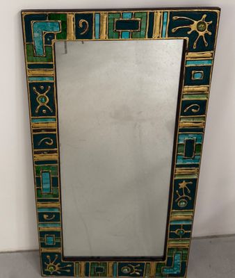 un miroir bleu et or orné de motifs géométriques