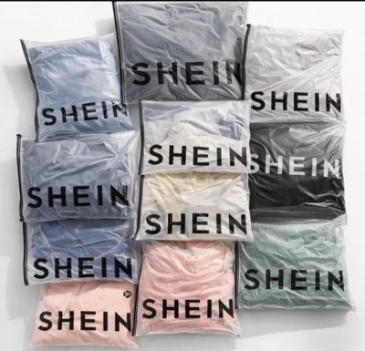 six bags filled with different types of shirts sitting on top of each other