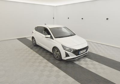 the white car is parked in the empty room of the building