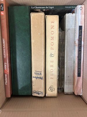 many books that are in a box on the shelf