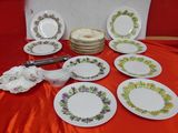 many plates that are sitting on a red table cloth