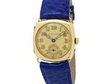 une photo d'une montre-bracelet en or avec un bracelet en cuir bleu
