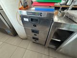 a stack of kitchen appliances sitting on a counter in a kitchen