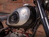 a close up of a motorcycle parked in front of a brick wall