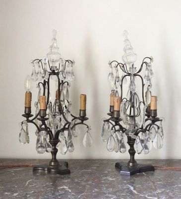 two small crystal chandeliers on a marble table