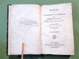 an open book with a wooden stick sticking out of it