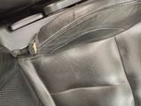 a close up of a seat in a car with a zipper on it