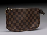 a close up of a brown and black purse on a gray surface