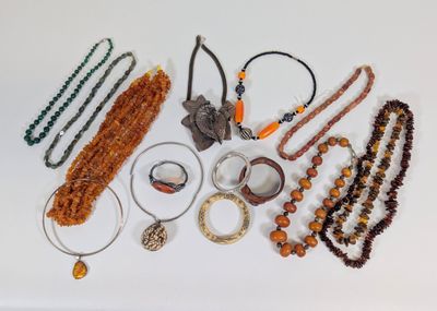 many necklaces and bracelets laid out on a table