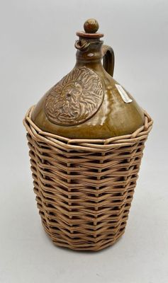 an image of a brown vase with a lid in a wicker basket