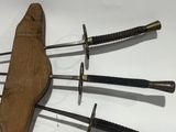 several different types of swords are displayed on a white surface