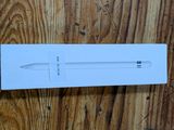 an apple pencil in a white box on a wooden surface