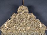 a mirror with a gold frame and a mirror with a face on it