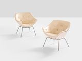 pair of lounge chairs in the shape of a shell