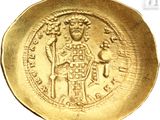 an image of a gold coin with an image of a man holding a sword