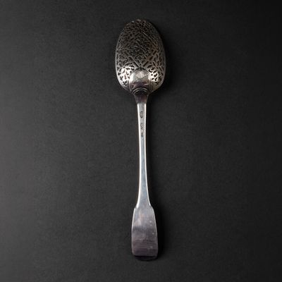 a spoon that is sitting on top of a black table