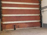 an empty garage with a red and white striped wall