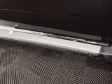 a close up of a car door sill with a sticker on it