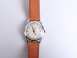 an image of a close up of a wrist watch on a white surface