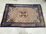 a rug on the floor with a person standing next to it