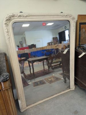 a large mirror sitting on the floor in a room