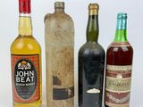 three bottles of alcohol are sitting next to each other on a white surface