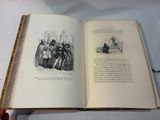 someone is holding a book open to a page with a picture of a group of people on it