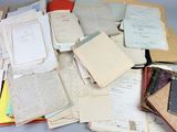 a pile of old books and papers on a table