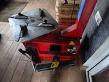 a red machine that is sitting on a wooden floor