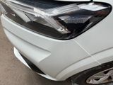 a close up of a car ' s headlight on the side of the road