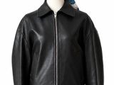 the woman is wearing a black leather jacket and a pink skirt