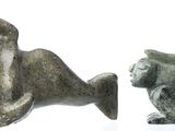 two figurines of a bear and a bear on a white surface
