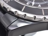 a close up of a watch with a black face