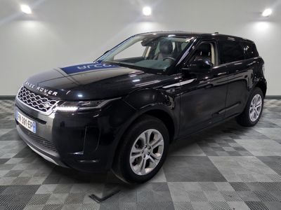 une Land Rover noire garée dans un garage au sol carrelé