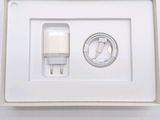 a white box with a charger and a cable in it