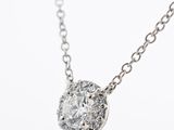 a close up of a diamond necklace on a chain