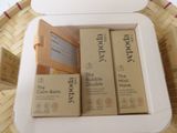 three boxes of soap sitting in a basket on a table