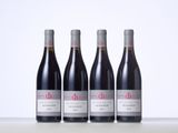three bottles of red wine sitting on top of a table